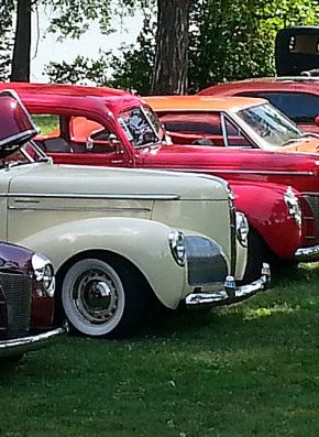 Vintage classic cars parked on grass