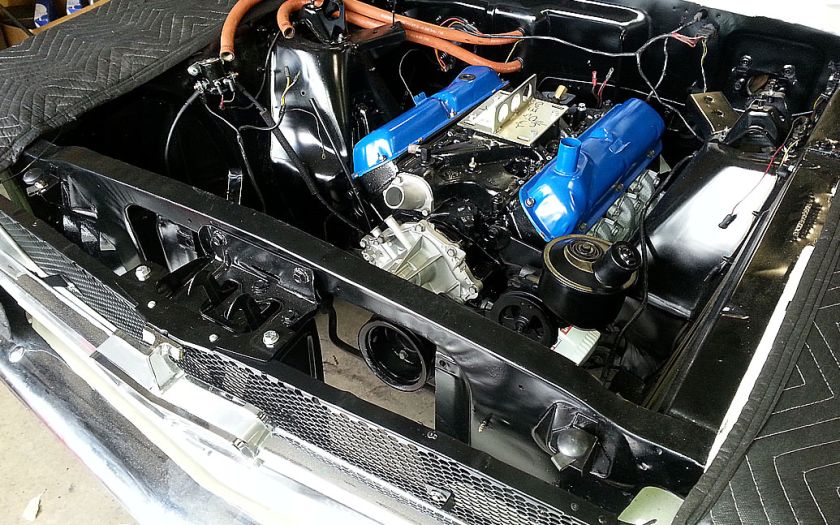 Car engine compartment with restored V8 engine