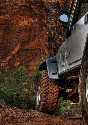 Jeep off-road vehicle navigating rocky terrain